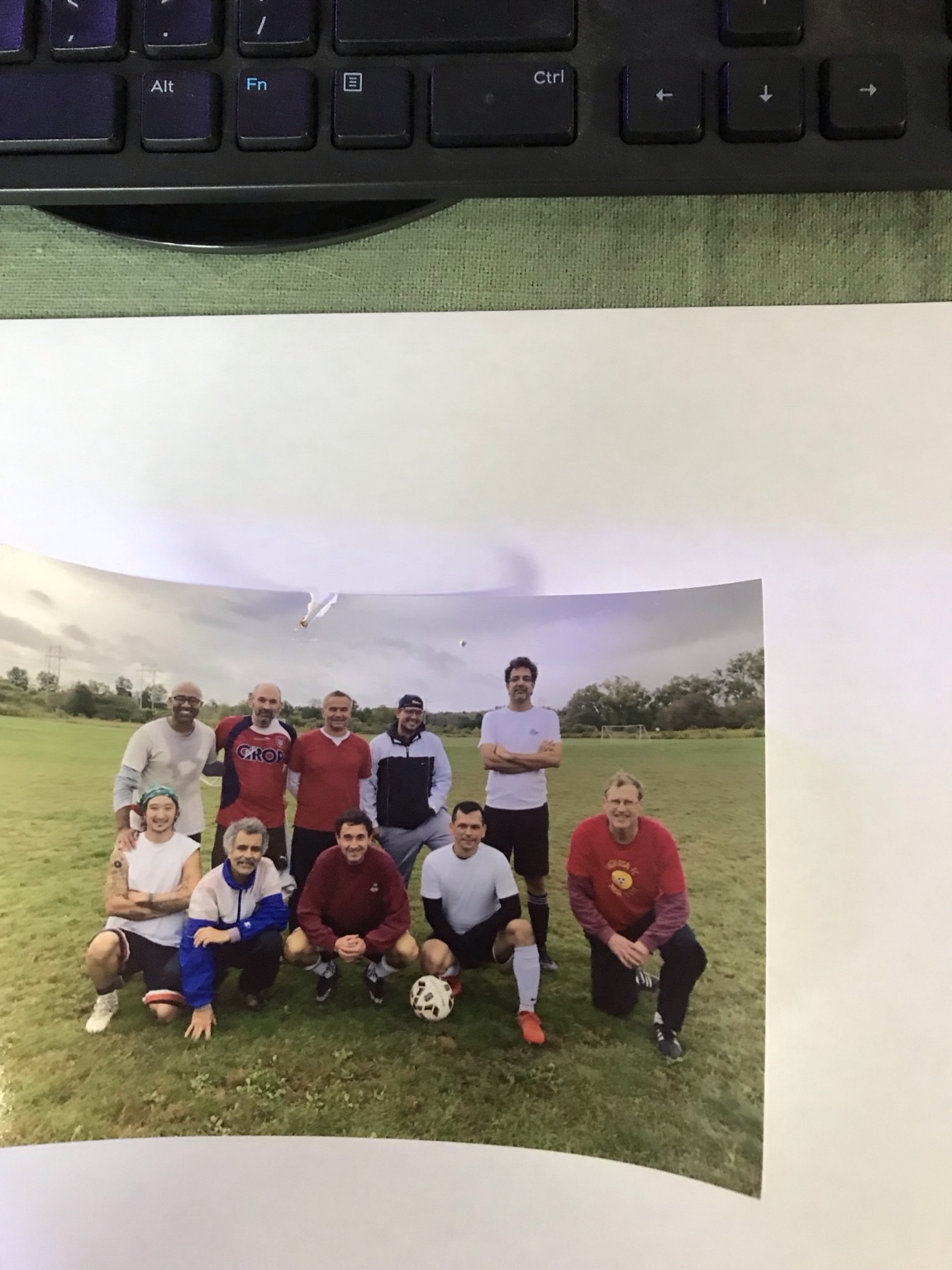 Soccer players posing together outdoors